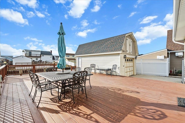 16 Gibbs Rd, Amity Harbor, NY 11701 - deck with an outdoor structure, outdoor dining space, and a garage