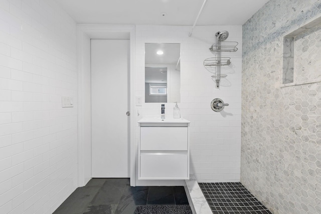 1696 Coral Rd, East Meadow, NY 11554 - full bath featuring tiled shower, vanity, tile walls, and tile patterned flooring