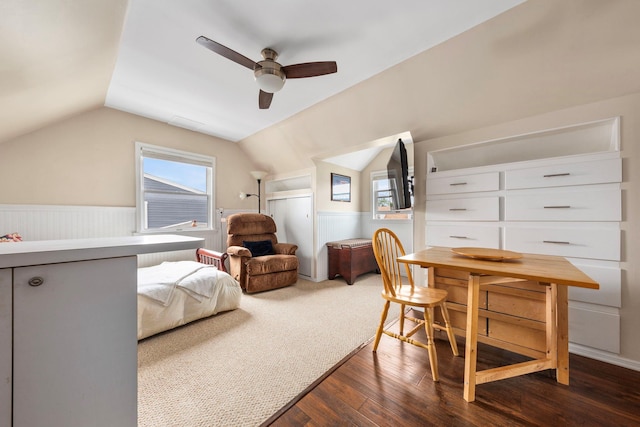 1696 Coral Rd, East Meadow, NY 11554 - bedroom with dark wood-style floors, vaulted ceiling, wainscoting, and a ceiling fan