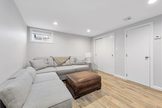 1696 Coral Rd, East Meadow, NY 11554 - living room featuring light wood-style flooring, recessed lighting, and baseboards