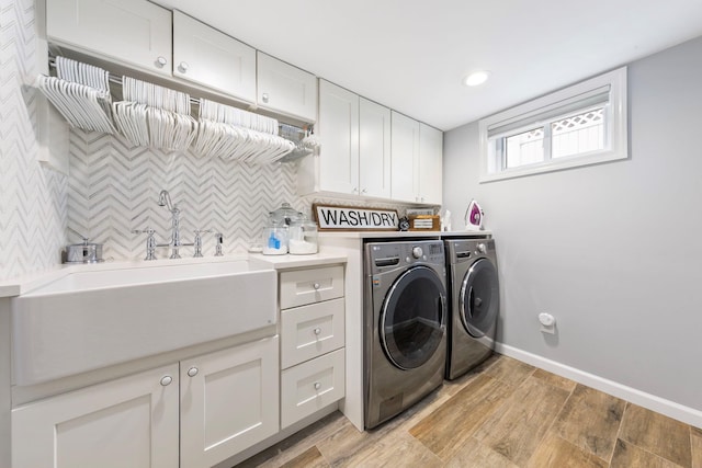 1696 Coral Rd, East Meadow, NY 11554 - laundry room with separate washer and dryer, light wood-style floors, cabinet space, baseboards, and recessed lighting