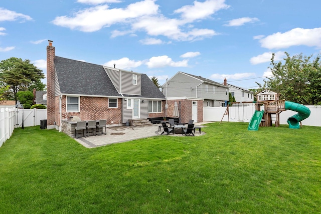 1696 Coral Rd, East Meadow, NY 11554 - rear view of house with a shingled roof, entry steps, a patio, a playground, and a chimney
