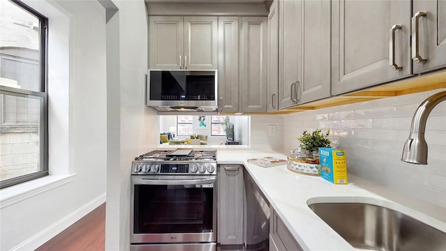 2611 Frederick Douglass Blvd Unit 5D, New York Manhattan, NY 10030 - kitchen with stainless steel appliances, a sink, light countertops, and decorative backsplash