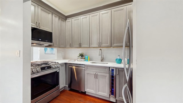 2611 Frederick Douglass Blvd Unit 5D, New York Manhattan, NY 10030 - kitchen featuring appliances with stainless steel finishes, a sink, light countertops, wine cooler, and backsplash