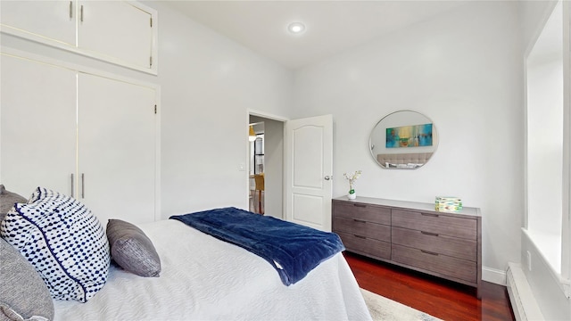 2611 Frederick Douglass Blvd Unit 5D, New York Manhattan, NY 10030 - bedroom with baseboard heating, dark wood-type flooring, recessed lighting, baseboards, and a closet