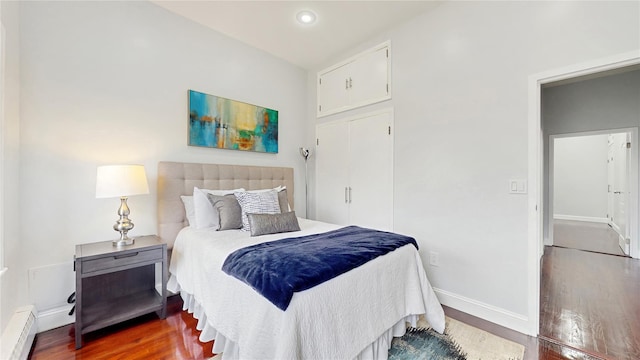 2611 Frederick Douglass Blvd Unit 5D, New York Manhattan, NY 10030 - bedroom featuring wood finished floors, a baseboard heating unit, baseboards, and recessed lighting
