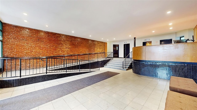 2611 Frederick Douglass Blvd Unit 5D, New York Manhattan, NY 10030 - welcome area with recessed lighting, brick wall, and stairway