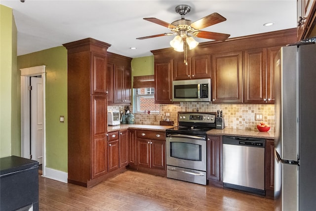 230 Pennyfield Ave, Bronx, NY 10465 - kitchen featuring stainless steel appliances, hardwood / wood-style flooring, ceiling fan, tasteful backsplash, and recessed lighting