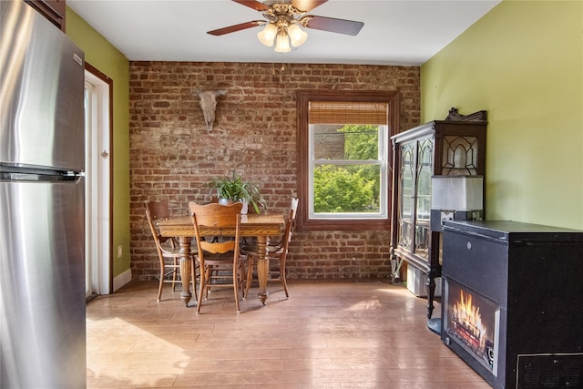 230 Pennyfield Ave, Bronx, NY 10465 - dining space with brick wall, wood finished floors, and a ceiling fan