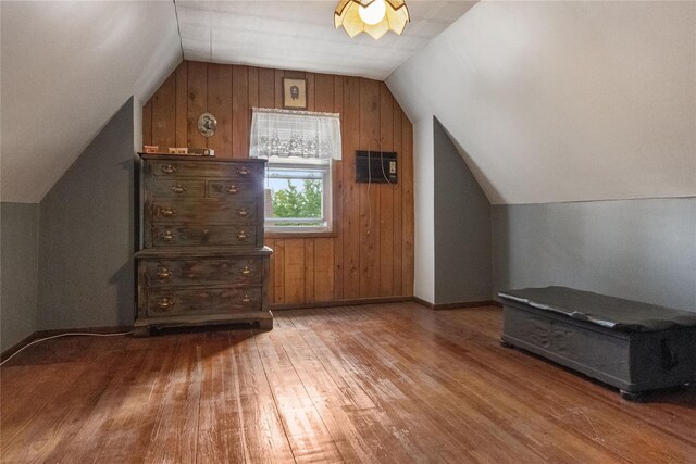 230 Pennyfield Ave, Bronx, NY 10465 - additional living space featuring wood finished floors, lofted ceiling, wooden walls, and baseboards