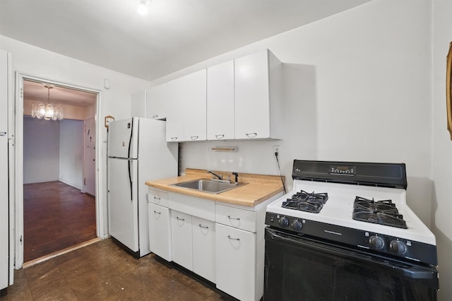 682 Tuckahoe Rd Unit 1A, Yonkers, NY 10710 - kitchen featuring gas range oven, a sink, freestanding refrigerator, and white cabinets