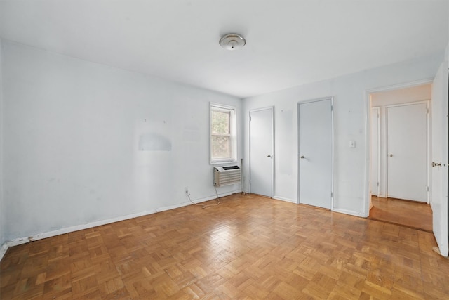 682 Tuckahoe Rd Unit 1A, Yonkers, NY 10710 - unfurnished bedroom with a wall mounted air conditioner, two closets, and baseboards