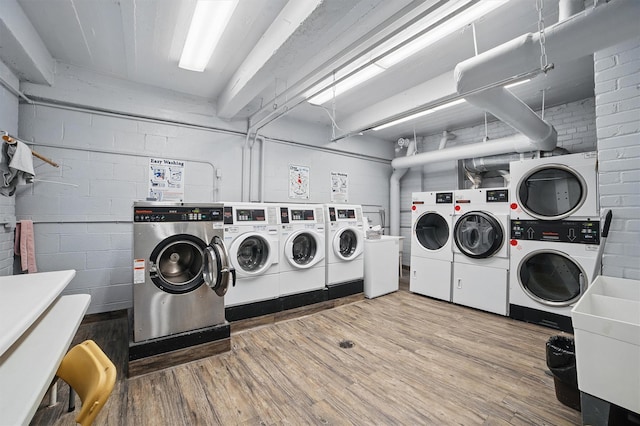 682 Tuckahoe Rd Unit 1A, Yonkers, NY 10710 - shared laundry with wood finished floors, washing machine and clothes dryer, estacked washer and dryer, and concrete block wall