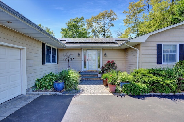 12 Bridle Path Ln, Port Jefferson, NY 11777 - entrance to property with solar panels and a garage