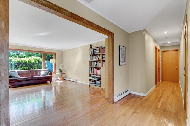 12 Bridle Path Ln, Port Jefferson, NY 11777 - corridor featuring baseboard heating, light wood-style flooring, a baseboard heating unit, baseboards, and ornamental molding