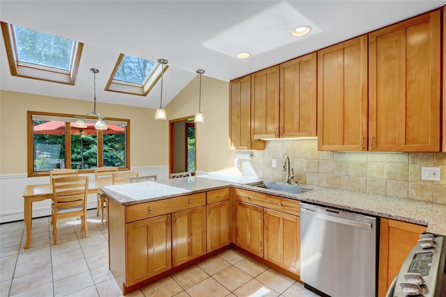 12 Bridle Path Ln, Port Jefferson, NY 11777 - kitchen with stainless steel dishwasher, a sink, light tile patterned floors, a skylight, and a wainscoted wall