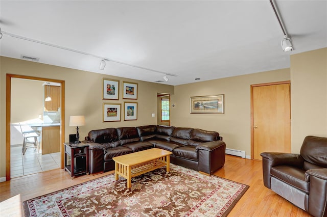 12 Bridle Path Ln, Port Jefferson, NY 11777 - living room with track lighting, a baseboard radiator, and light wood finished floors