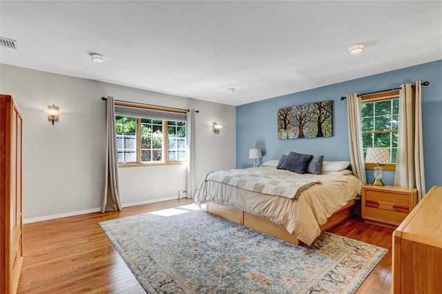 12 Bridle Path Ln, Port Jefferson, NY 11777 - bedroom with light wood-style flooring, baseboards, and a baseboard radiator