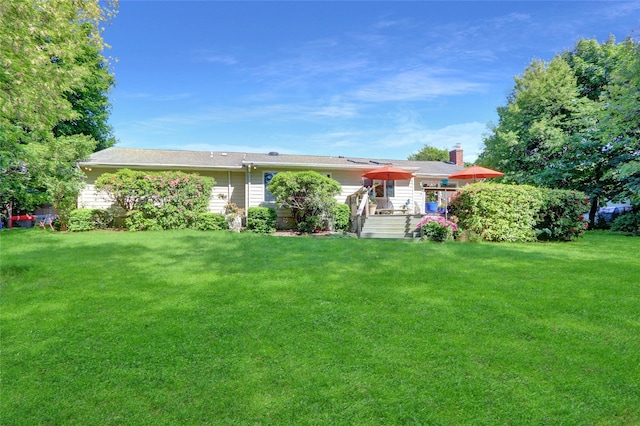 12 Bridle Path Ln, Port Jefferson, NY 11777 - rear view of property featuring a deck, a lawn, and a chimney