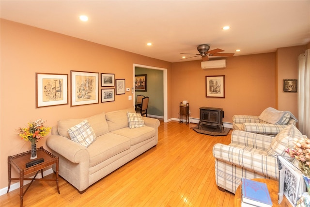 57 Decker Dr, Washingtonville, NY 10992 - living room featuring a wall mounted air conditioner, a wood stove, a ceiling fan, recessed lighting, and light wood-type flooring