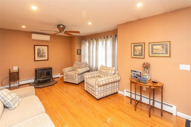 57 Decker Dr, Washingtonville, NY 10992 - living room featuring a wall unit AC, a baseboard radiator, a wood stove, ceiling fan, and recessed lighting