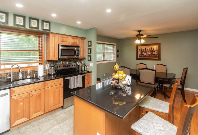 57 Decker Dr, Washingtonville, NY 10992 - kitchen with stainless steel appliances, a sink, decorative backsplash, ceiling fan, and recessed lighting