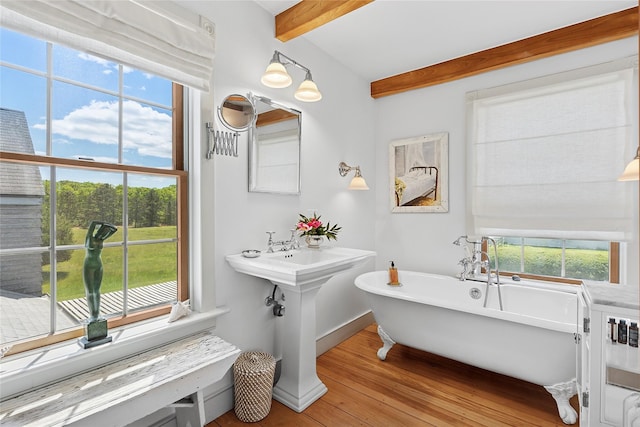 140AND144 Damascus Rd, East Quogue, NY 11942 - full bathroom featuring a freestanding tub, wood finished floors, beam ceiling, and plenty of natural light