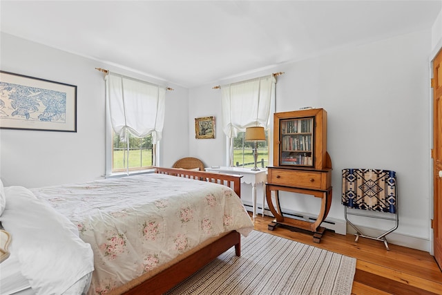 140AND144 Damascus Rd, East Quogue, NY 11942 - bedroom with hardwood / wood-style flooring and a baseboard heating unit