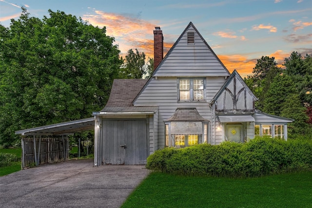 61 Spackenkill Rd, Poughkeepsie, NY 12603 - english style home with a chimney, driveway, and a carport