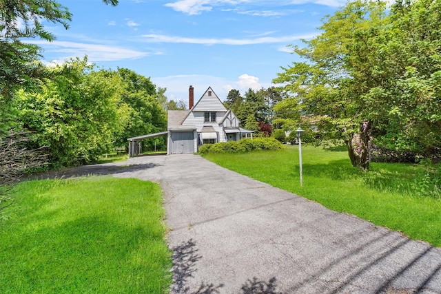 61 Spackenkill Rd, Poughkeepsie, NY 12603 - view of front of home featuring asphalt driveway, a chimney, a front yard, and a carport