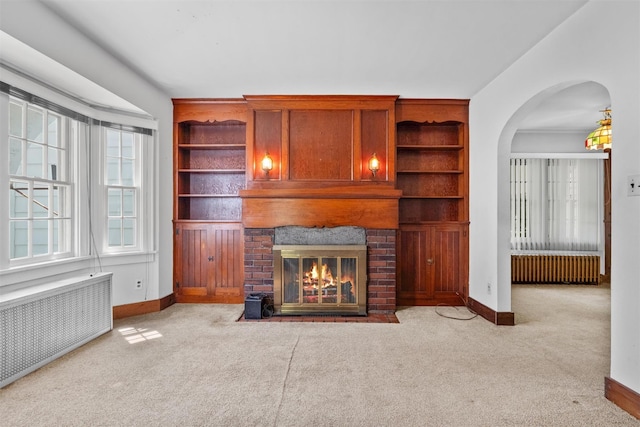 61 Spackenkill Rd, Poughkeepsie, NY 12603 - unfurnished living room with radiator heating unit, carpet, baseboards, and a brick fireplace
