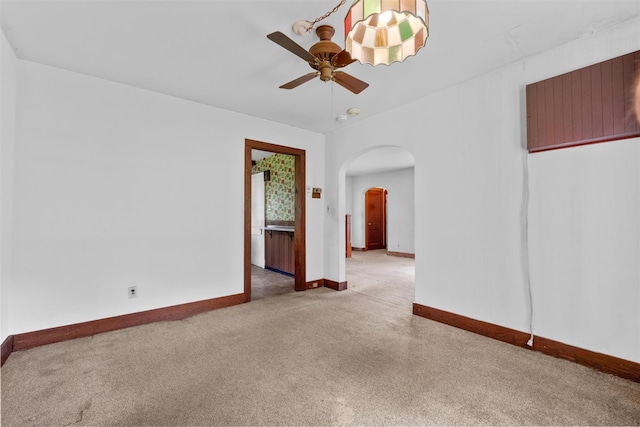 61 Spackenkill Rd, Poughkeepsie, NY 12603 - carpeted empty room with arched walkways, a ceiling fan, and baseboards