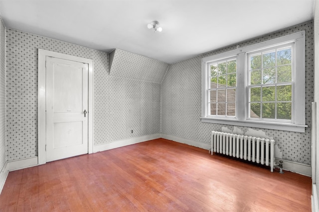 61 Spackenkill Rd, Poughkeepsie, NY 12603 - additional living space featuring radiator, wallpapered walls, wood finished floors, and baseboards