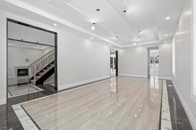 19 Maple Ave, Cedarhurst, NY 11516 - unfurnished room featuring a raised ceiling, stairway, recessed lighting, a fireplace, and baseboards