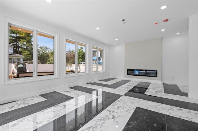 19 Maple Ave, Cedarhurst, NY 11516 - unfurnished living room with recessed lighting, marble tiled floors, a glass covered fireplace, and baseboards