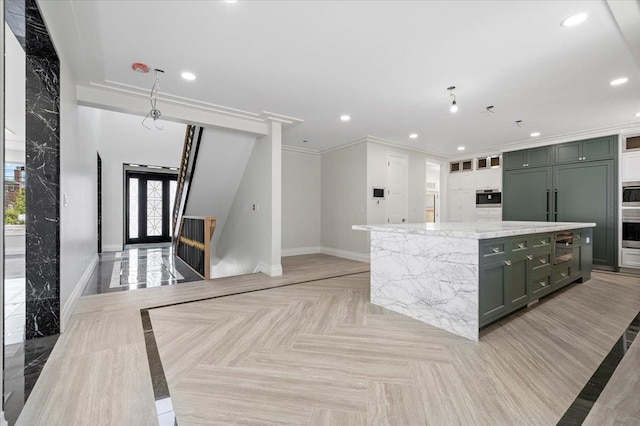 19 Maple Ave, Cedarhurst, NY 11516 - kitchen featuring baseboards, recessed lighting, light stone counters, ornamental molding, and a center island