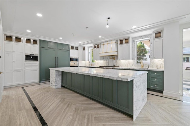 19 Maple Ave, Cedarhurst, NY 11516 - kitchen with green cabinetry, custom range hood, a spacious island, tasteful backsplash, and recessed lighting