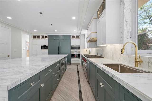 19 Maple Ave, Cedarhurst, NY 11516 - kitchen featuring a sink, white cabinetry, light stone counters, decorative backsplash, and recessed lighting