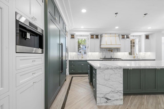19 Maple Ave, Cedarhurst, NY 11516 - kitchen featuring custom range hood, stainless steel microwave, light stone countertops, a sink, and glass insert cabinets
