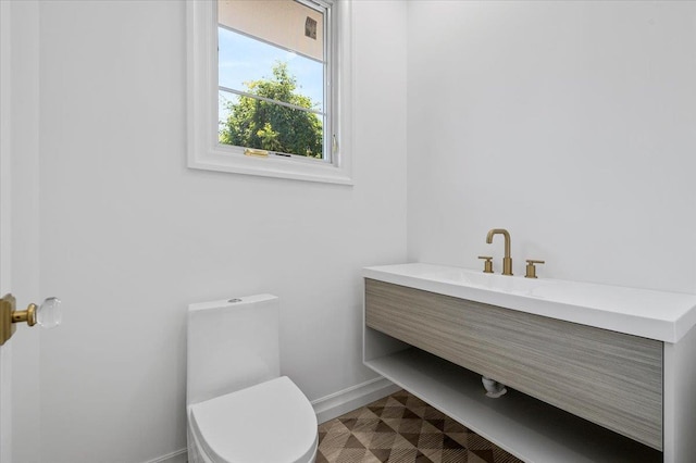 19 Maple Ave, Cedarhurst, NY 11516 - half bathroom featuring toilet, baseboards, and vanity