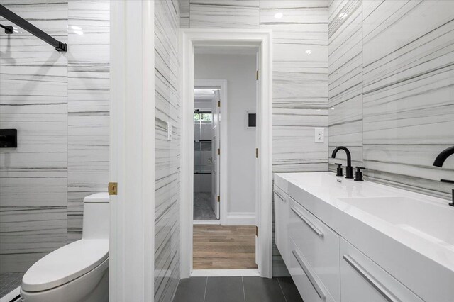 19 Maple Ave, Cedarhurst, NY 11516 - bathroom with tile walls, toilet, tile patterned floors, and double vanity