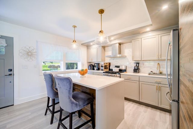 322 Noxon Rd, Poughkeepsie, NY 12603 - kitchen featuring stainless steel appliances, wall chimney exhaust hood, a sink, light wood finished floors, and ornamental molding