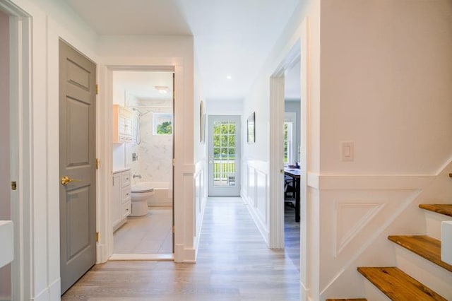 322 Noxon Rd, Poughkeepsie, NY 12603 - hallway with light wood-style flooring and stairs