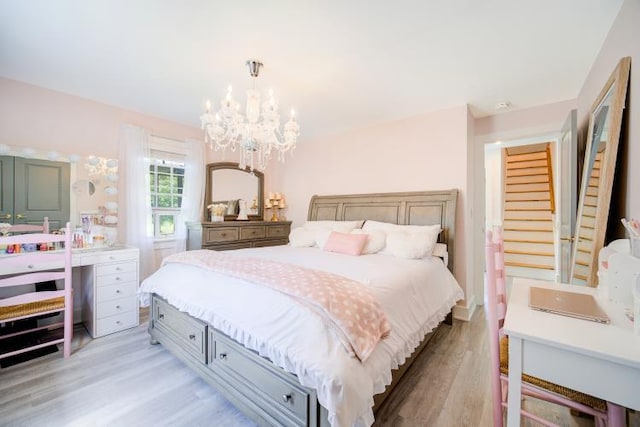 322 Noxon Rd, Poughkeepsie, NY 12603 - bedroom featuring light wood finished floors and a chandelier