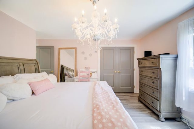 322 Noxon Rd, Poughkeepsie, NY 12603 - bedroom featuring a chandelier, light wood-style floors, and a closet