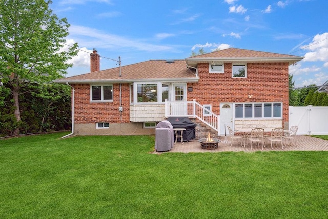 5 Coventry Rd, Syosset, NY 11791 - rear view of property featuring a chimney, a patio area, a fire pit, brick siding, and a gate