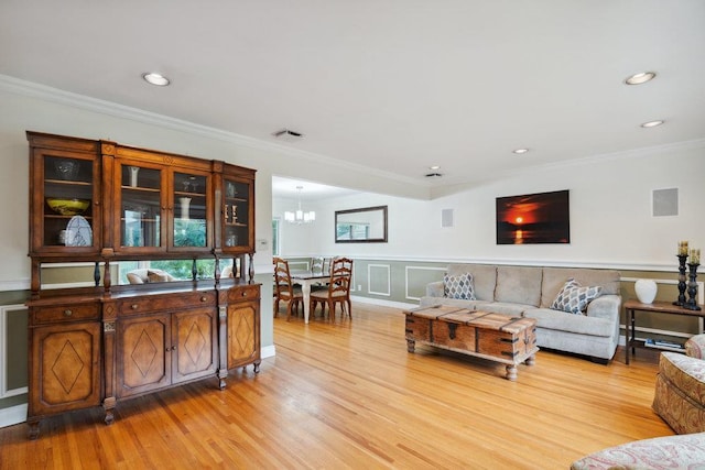 5 Coventry Rd, Syosset, NY 11791 - living room with light wood finished floors, crown molding, a chandelier, recessed lighting, and a wainscoted wall