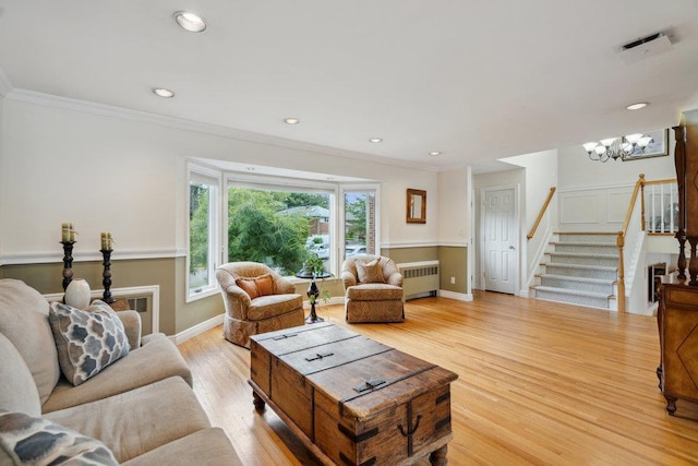 5 Coventry Rd, Syosset, NY 11791 - living area with radiator heating unit, stairs, light wood-type flooring, a chandelier, and baseboards