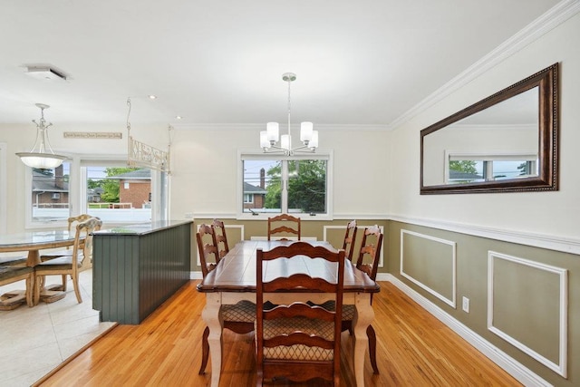5 Coventry Rd, Syosset, NY 11791 - dining area with a chandelier, crown molding, a wainscoted wall, and light wood-type flooring