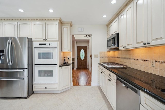 5 Coventry Rd, Syosset, NY 11791 - kitchen with appliances with stainless steel finishes, recessed lighting, tasteful backsplash, light tile patterned flooring, and cream cabinets